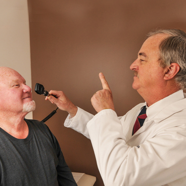 Brown Neurology patient with doctor